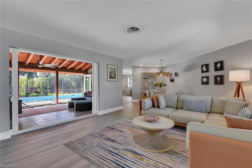 2328 Clipper Way Naples, FL 34104 - Photo 11 of 44 a living room with furniture and a large window