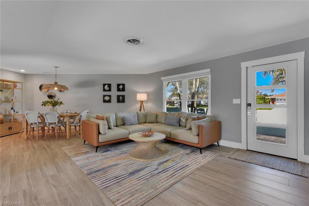 2328 Clipper Way Naples, FL 34104 - Photo 12 of 44 a living room with furniture and wooden floor