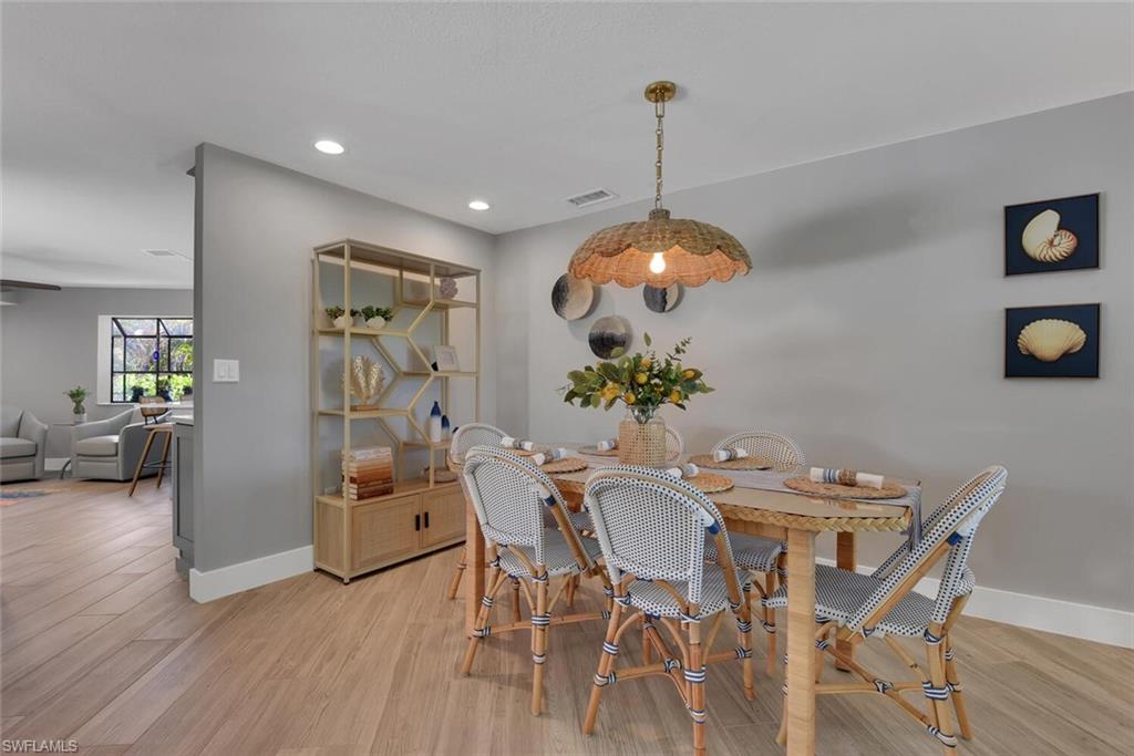2328 Clipper Way Naples, FL 34104 - Photo 13 of 44 a view of a dining room with furniture and wooden floor