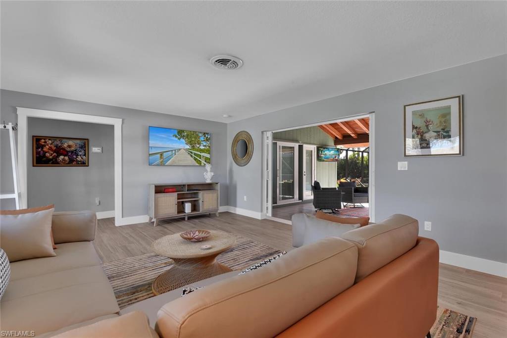 2328 Clipper Way Naples, FL 34104 - Photo 15 of 44 a living room with furniture and a flat screen tv