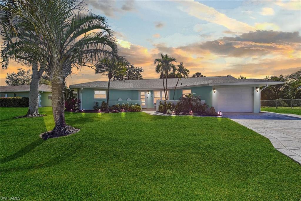 2328 Clipper Way Naples, FL 34104 - Photo 2 of 44 a front view of a house with garden