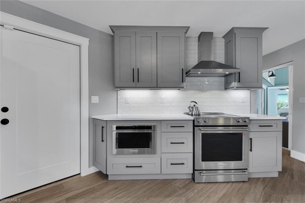 2328 Clipper Way Naples, FL 34104 - Photo 21 of 44 a kitchen with stainless steel appliances a stove and cabinets