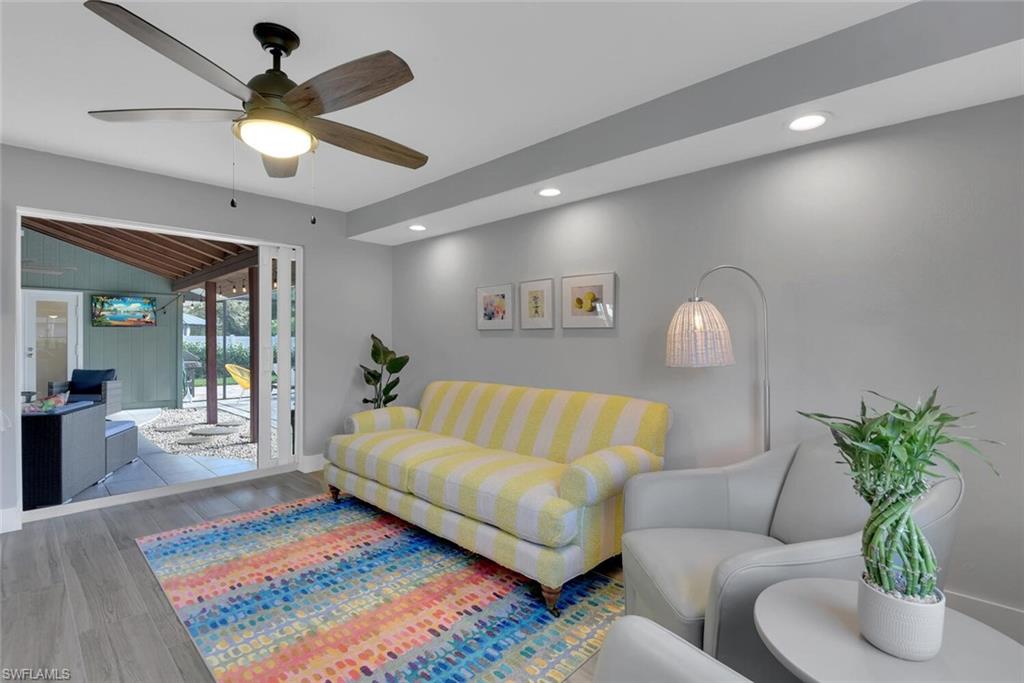 2328 Clipper Way Naples, FL 34104 - Photo 23 of 44 a living room with furniture potted plant and a rug