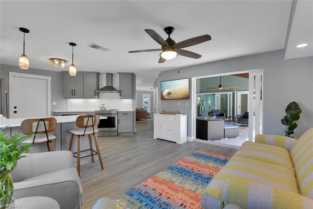 2328 Clipper Way Naples, FL 34104 - Photo 24 of 44 a living room with furniture and kitchen view