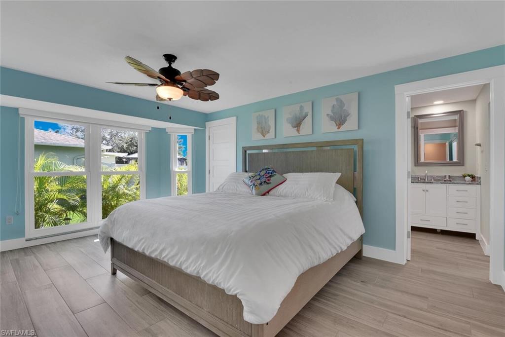 2328 Clipper Way Naples, FL 34104 - Photo 27 of 44 a bedroom with a large bed and a large window