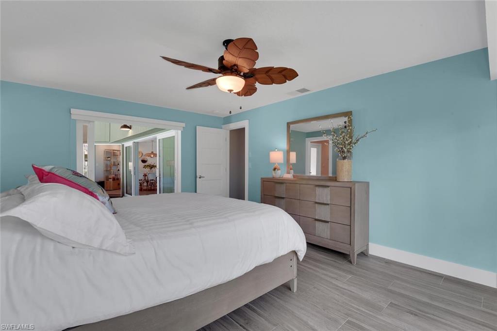 2328 Clipper Way Naples, FL 34104 - Photo 28 of 44 a bedroom with a bed and a chandelier