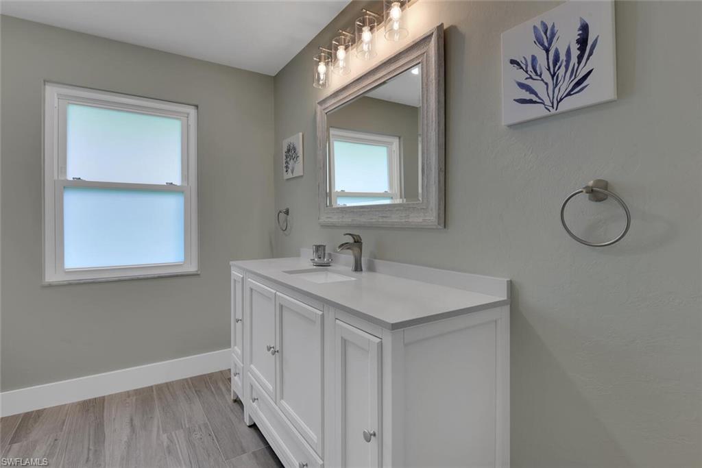 2328 Clipper Way Naples, FL 34104 - Photo 32 of 44 a bathroom with 2 sink and a mirror