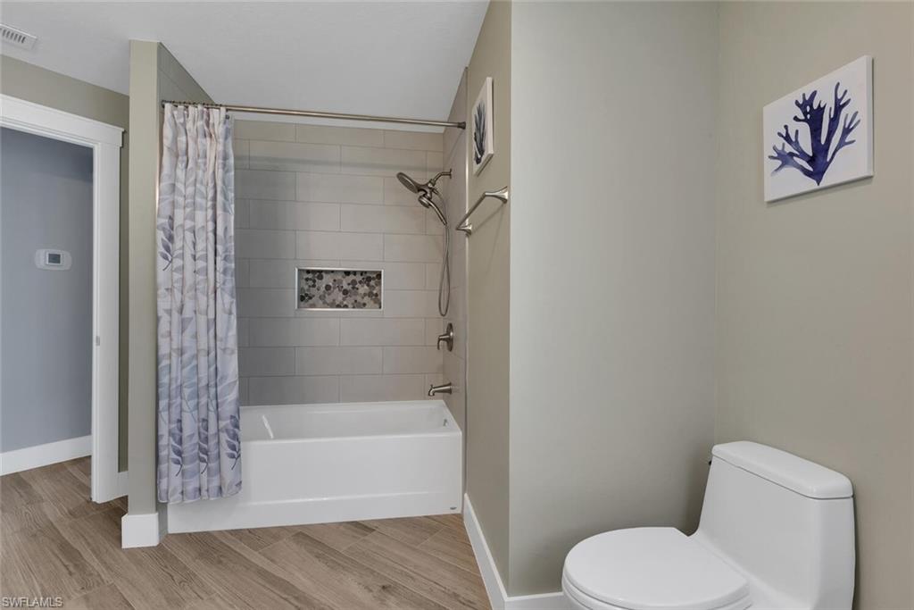 2328 Clipper Way Naples, FL 34104 - Photo 34 of 44 a bathroom with a shower and toilet