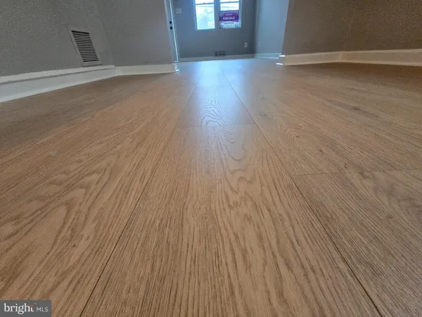 a view of a room with wooden floor