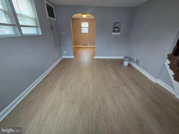 wooden floor in an empty room with a window
