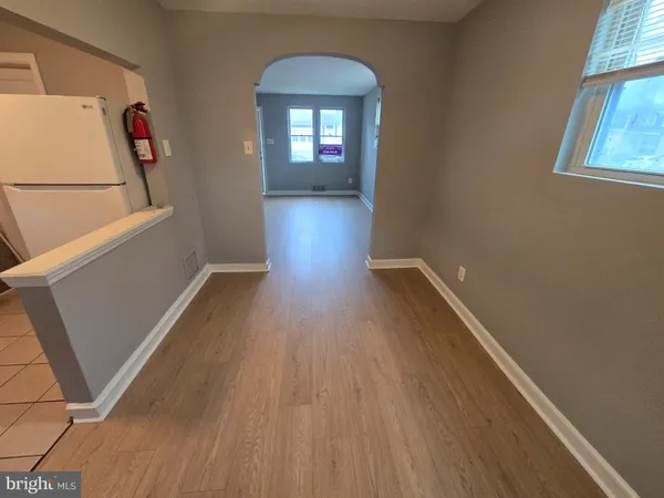 a view of a room with wooden floor and a window