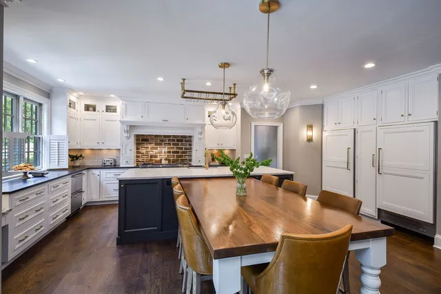 a kitchen with granite countertop white cabinets and window
