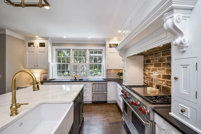 a living room with furniture fireplace and a large window