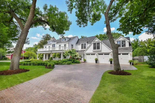 a front view of a house with a garden and yard