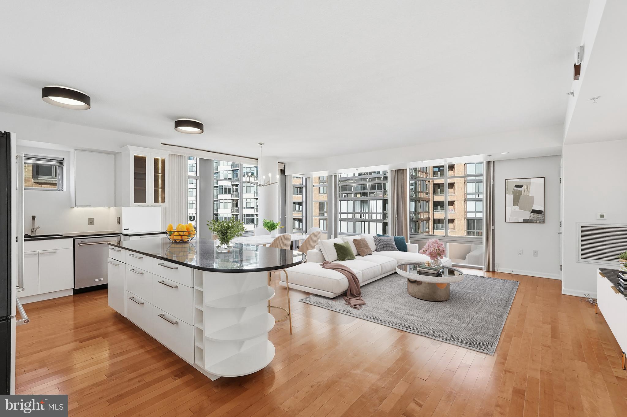 a kitchen with stainless steel appliances granite countertop a sink and wooden floor
