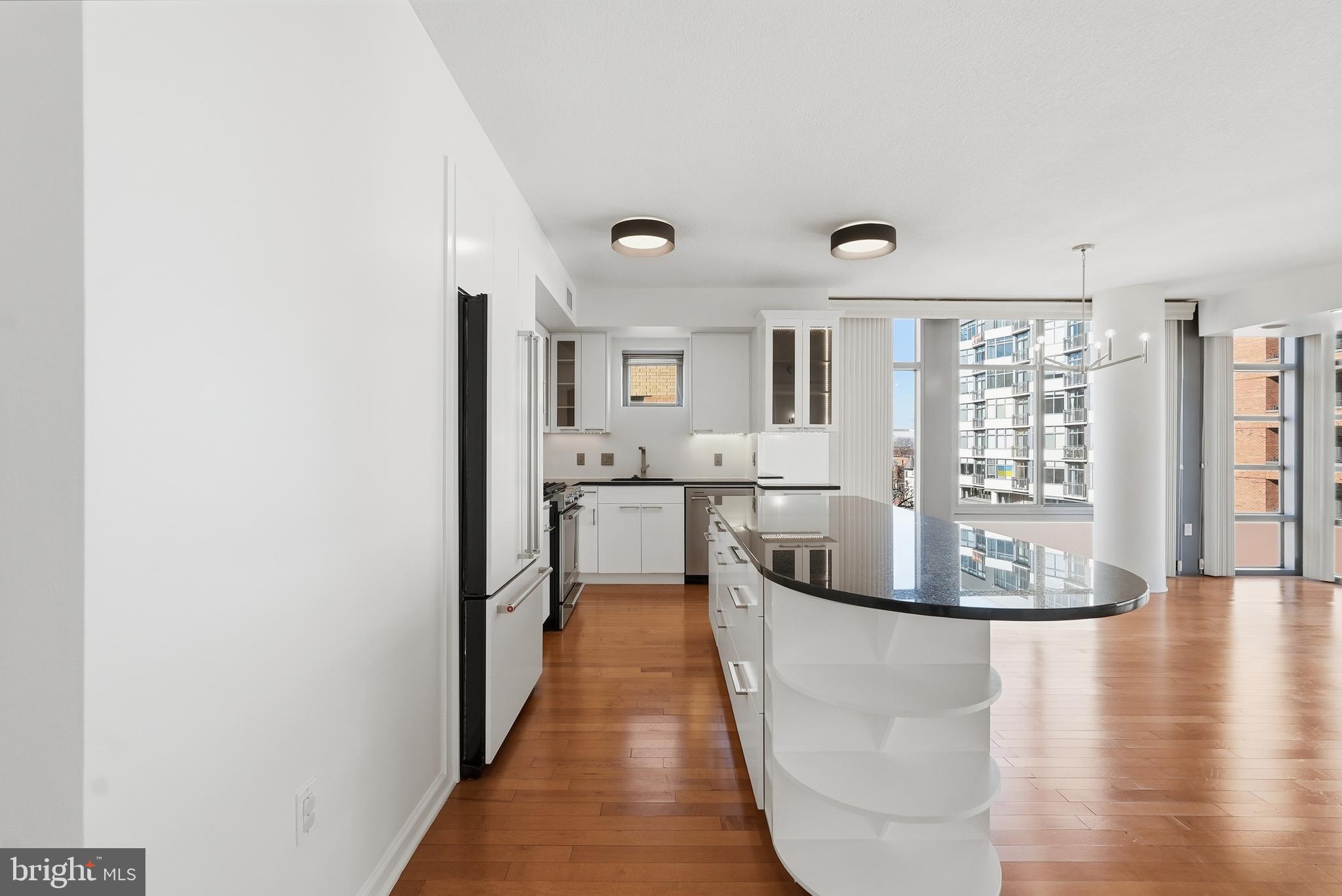 440 L Street Northwest, Unit 805 Washington, DC 20001 - Photo 12 of 38 a living room with stainless steel appliances granite countertop a couch and a view of kitchen