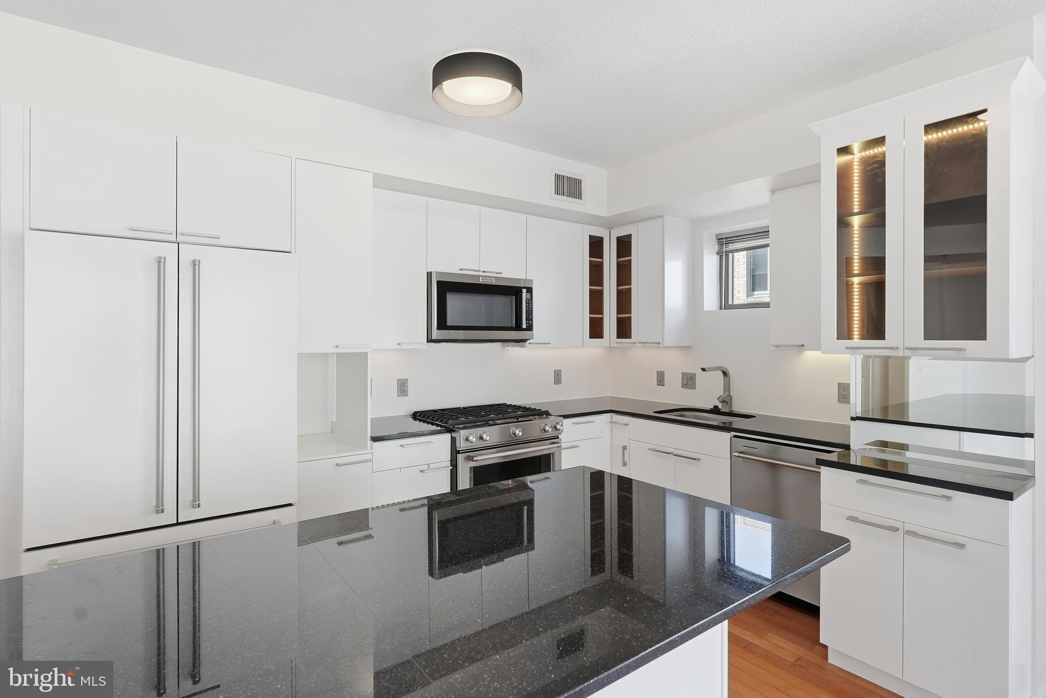 440 L Street Northwest, Unit 805 Washington, DC 20001 - Photo 13 of 38 a kitchen with stainless steel appliances granite countertop a stove a sink and a refrigerator
