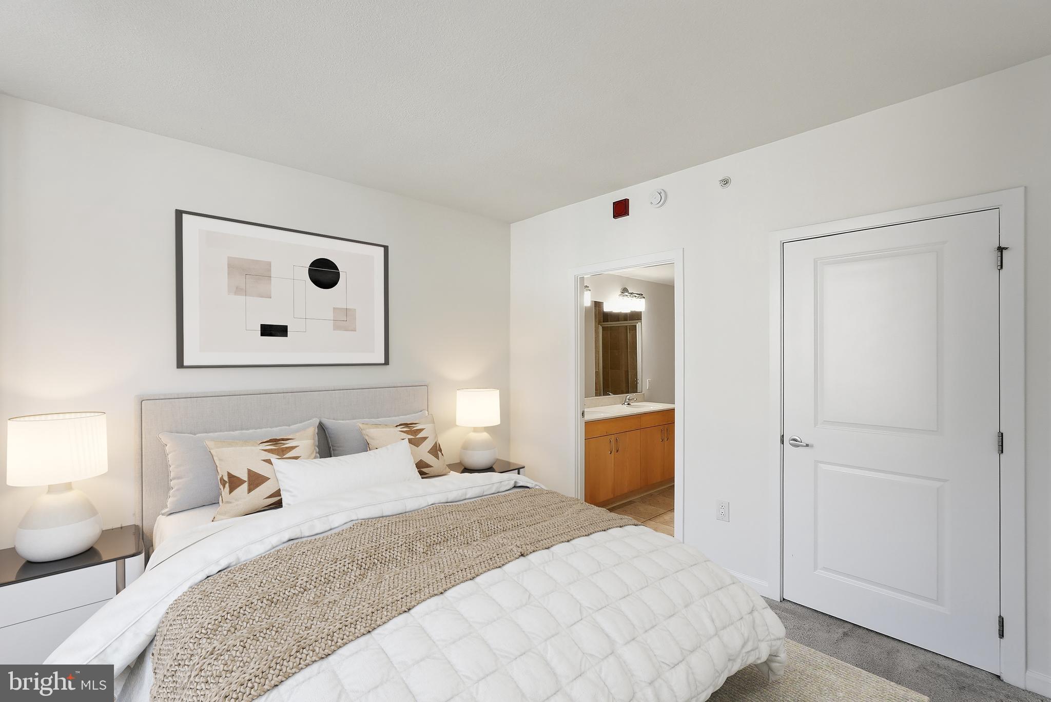 440 L Street Northwest, Unit 805 Washington, DC 20001 - Photo 21 of 38 a bedroom with a bed and a lamp on dresser