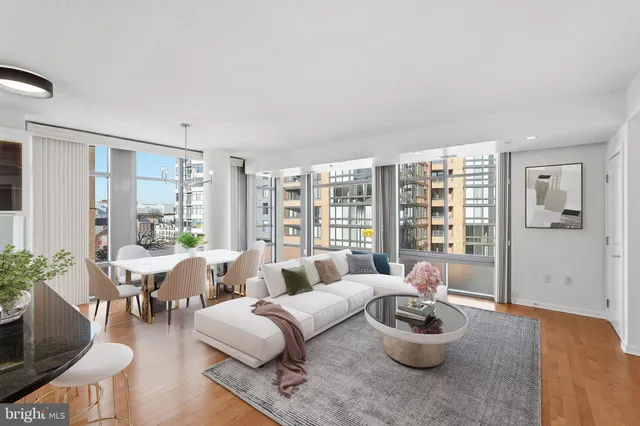 a large kitchen with stainless steel appliances granite countertop a large counter top and a wooden floors