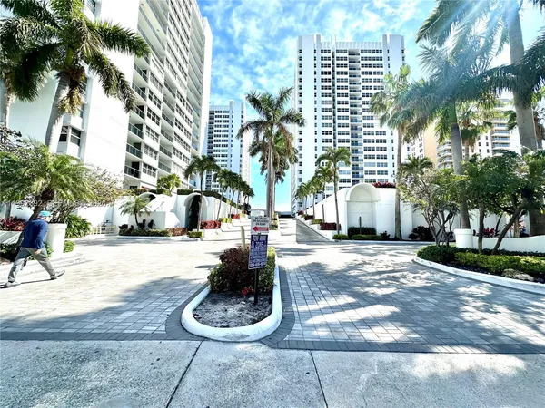 a house with palm tree in front of it