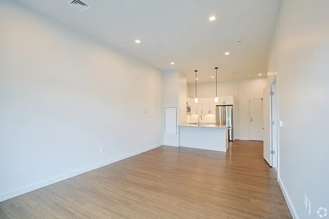 a view of a kitchen with a refrigerator and a sink