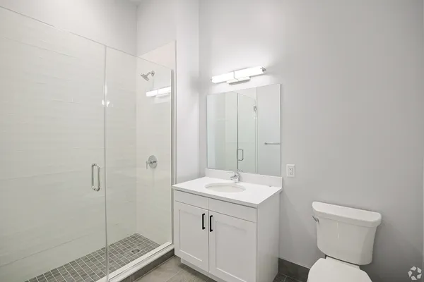a bathroom with a toilet sink and shower