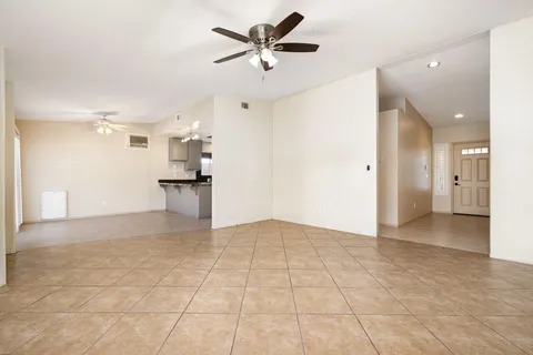 a view of a kitchen with a sink and a refrigerator