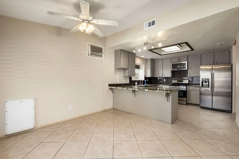 a kitchen with cabinets and stainless steel appliances