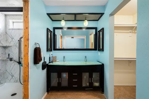 a bathroom with a double vanity sink and a mirror