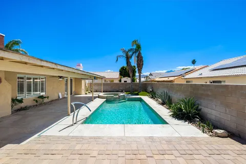 a view of a backyard with furniture