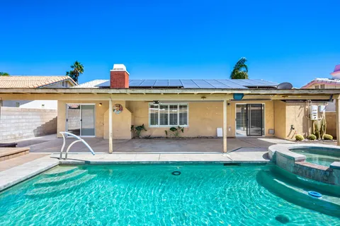 a view of a house with backyard porch and sitting area