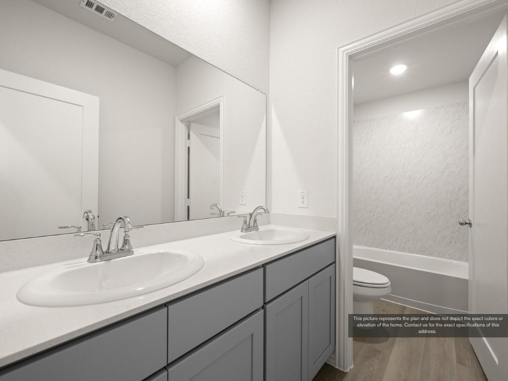 1805 Zelvia Lane Waco, TX 76708 - Photo 18 of 22 a bathroom with a granite countertop sink toilet and shower