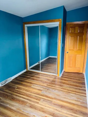 a view of a room with wooden floor