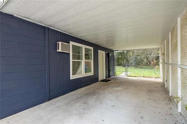 a view of an house with backyard and floor to ceiling window