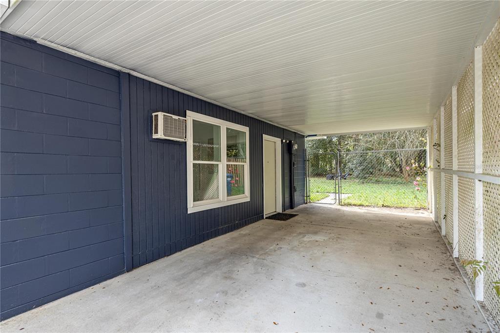 16675 Southwest 143rd Avenue Archer, FL 32618 - Photo 19 of 26 a view of an house with backyard and floor to ceiling window