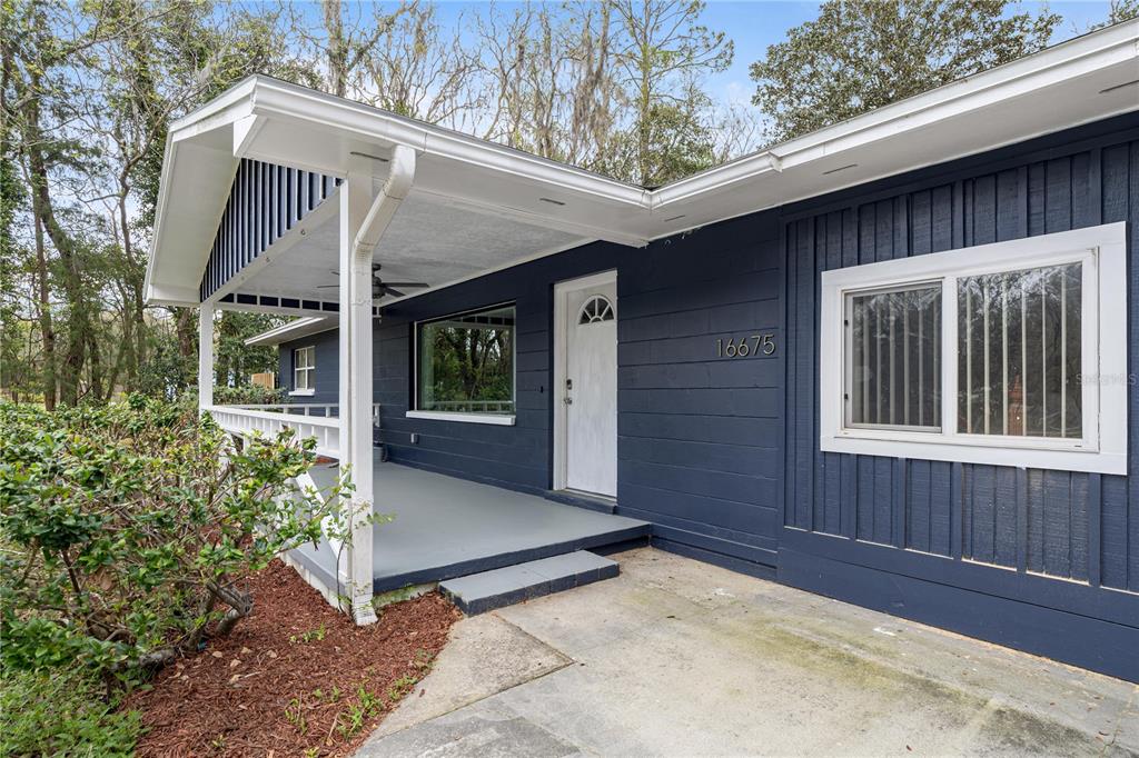 16675 Southwest 143rd Avenue Archer, FL 32618 - Photo 2 of 26 a view of house with backyard and glass windows