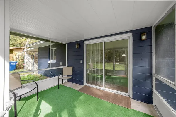 a view of an house with backyard porch and furniture