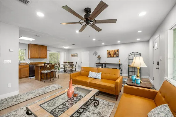a living room with furniture and wooden floor