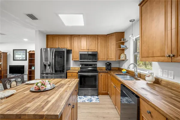 a kitchen with stainless steel appliances kitchen island granite countertop a sink and cabinets