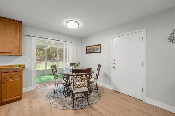 a dining room with furniture and wooden floor
