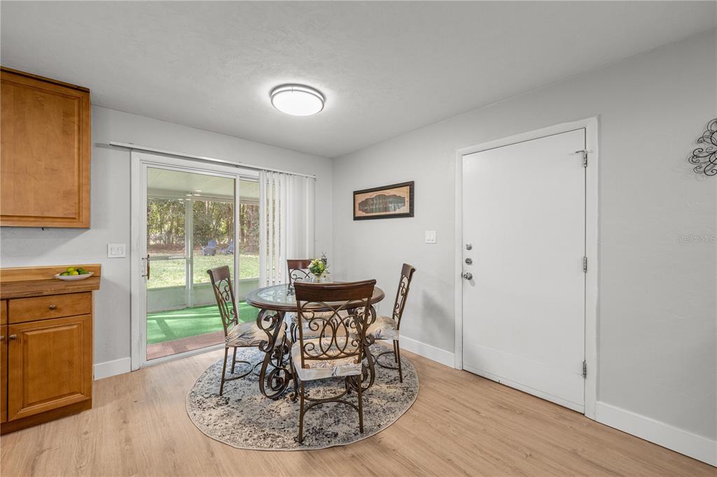 16675 Southwest 143rd Avenue Archer, FL 32618 - Photo 7 of 26 a dining room with furniture and wooden floor