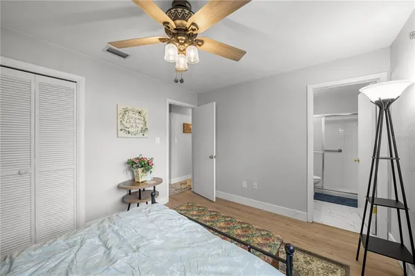 a bedroom with a bed and a chandelier