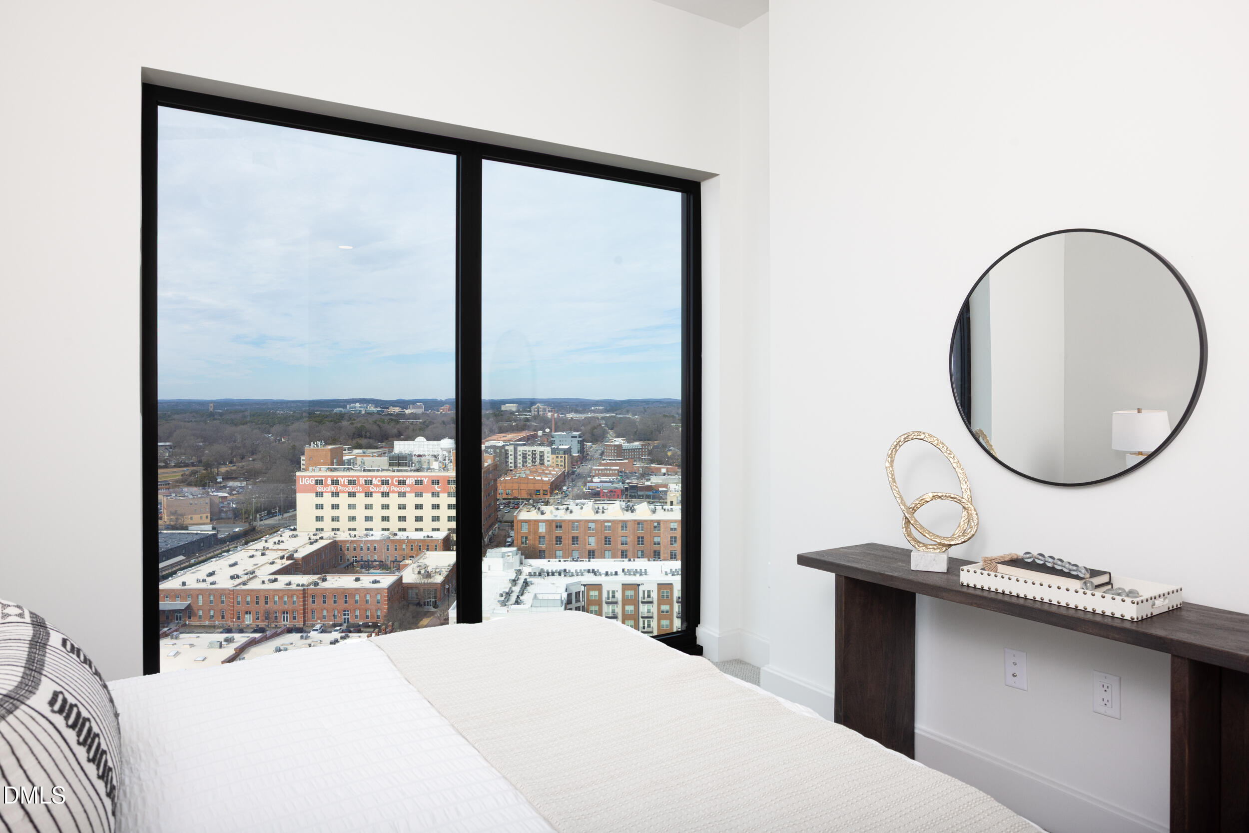 115 Morris Street, Unit 2010 Durham, NC 27701 - Photo 27 of 49 a bedroom with a large bed and a large window