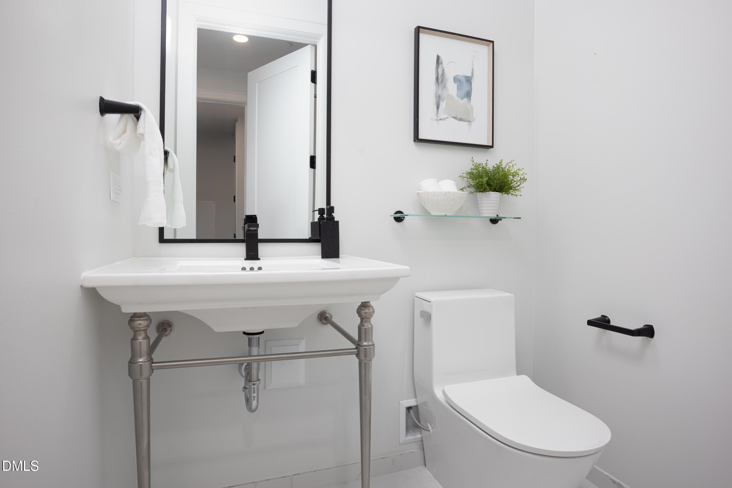 115 Morris Street, Unit 2010 Durham, NC 27701 - Photo 28 of 49 a bathroom with a sink a toilet and mirror