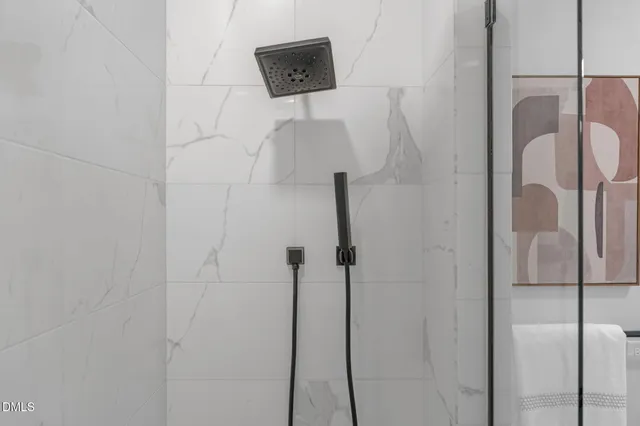 a view of a balcony with chairs and a potted plant