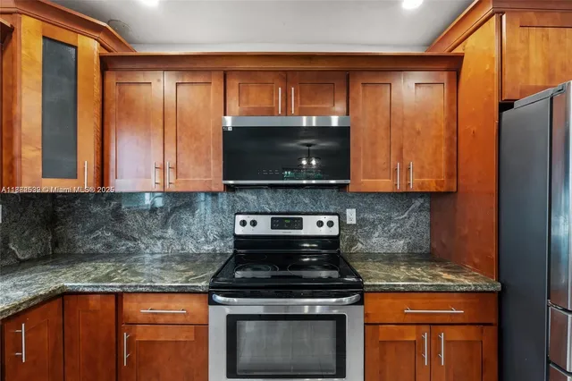 a kitchen with granite countertop a sink and a window