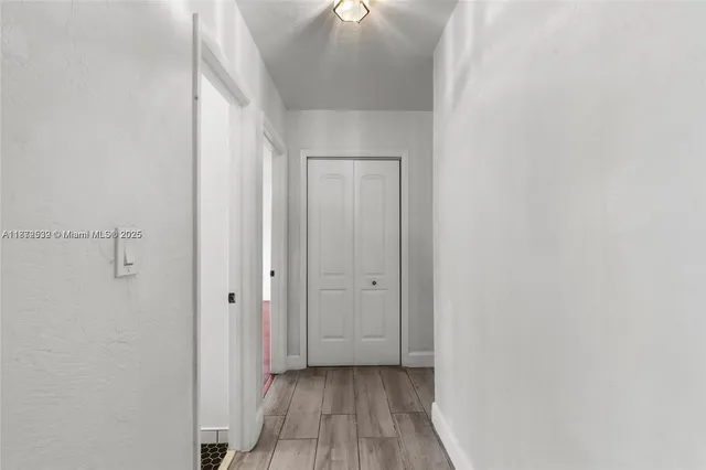 a view of hallway with wooden floor