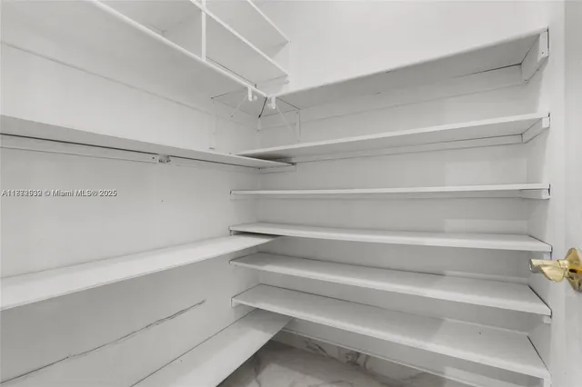 a view of an empty room with closet