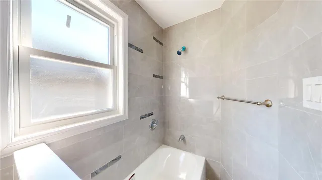 a bathroom with a toilet shower and a sink