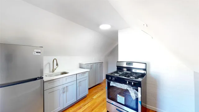 a view of a hallway with wooden floor and windows